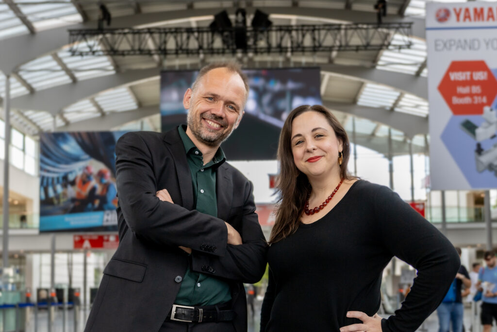 Odense Robotics CEO Søren Elmer Kristensen (left) and PRN Interim Executive Director Jenn Apicella (right) gathered in Munich to announce their new transatlantic partnership.